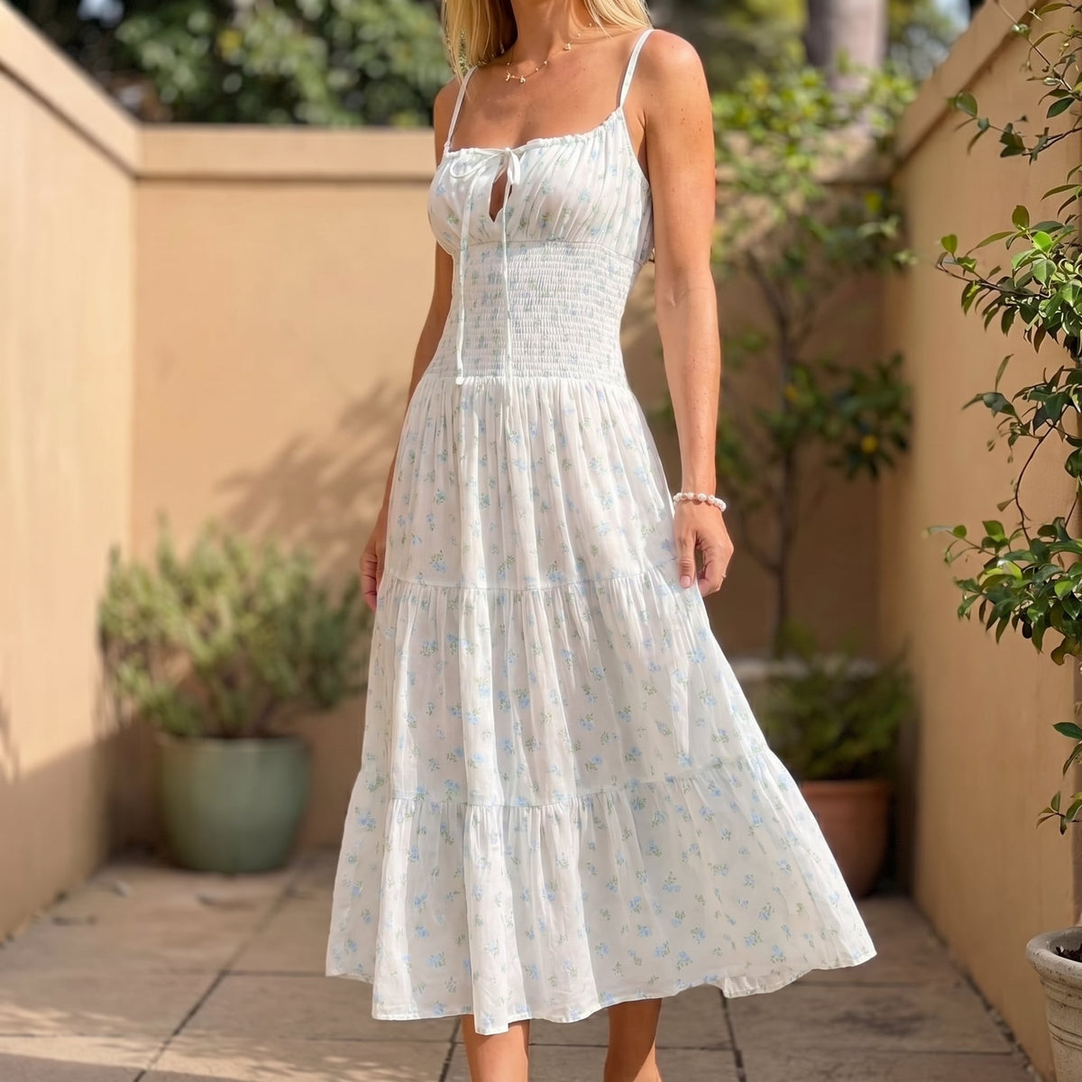 Zinnia Floral Midi Sundress in White in a sunlit courtyard