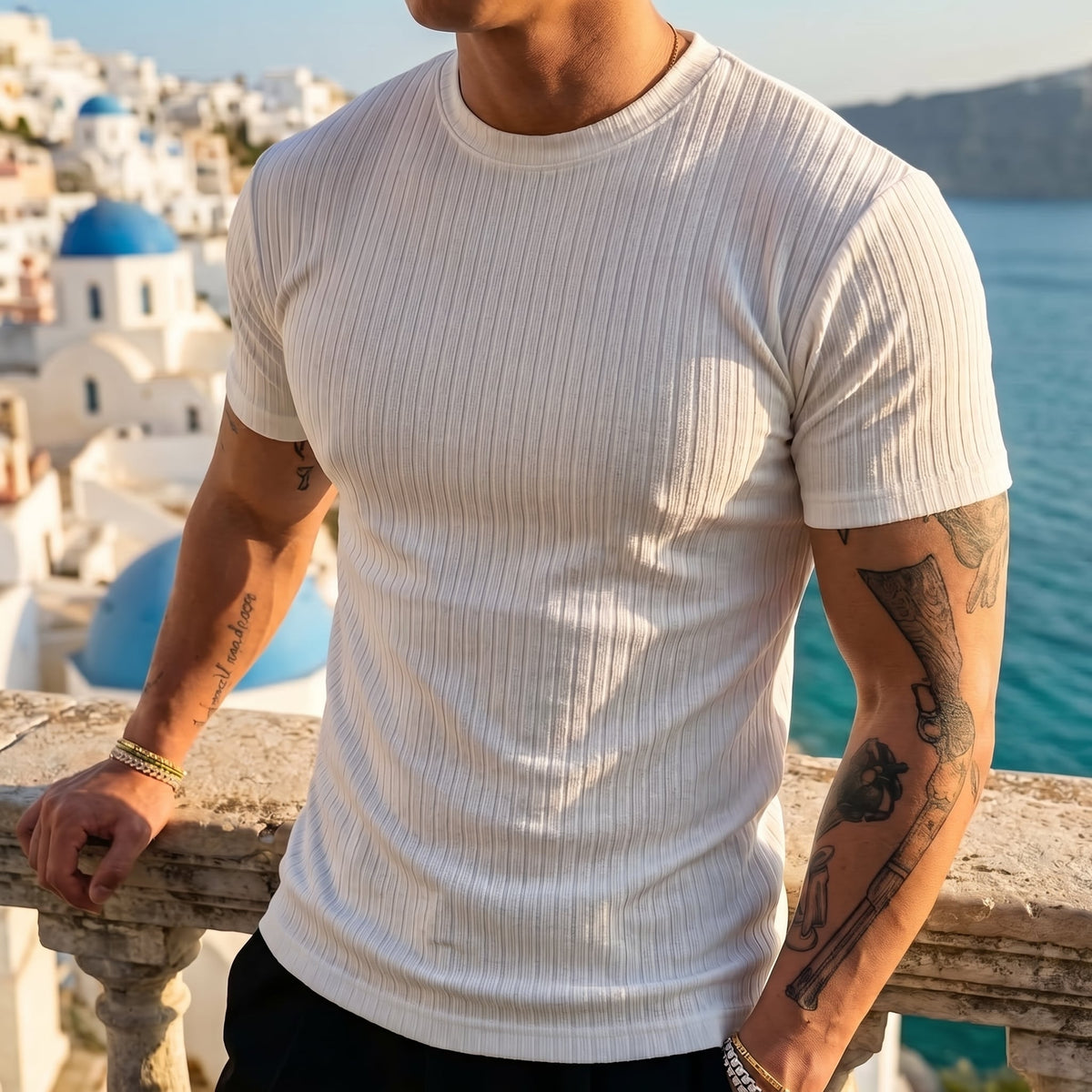Bexley Men's Ribbed Stretch Crew Tee worn on a terrace overlooking a coastal town