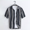 Cortez Men's Linen Button-Up Shirt hanging over a white top against a light wall