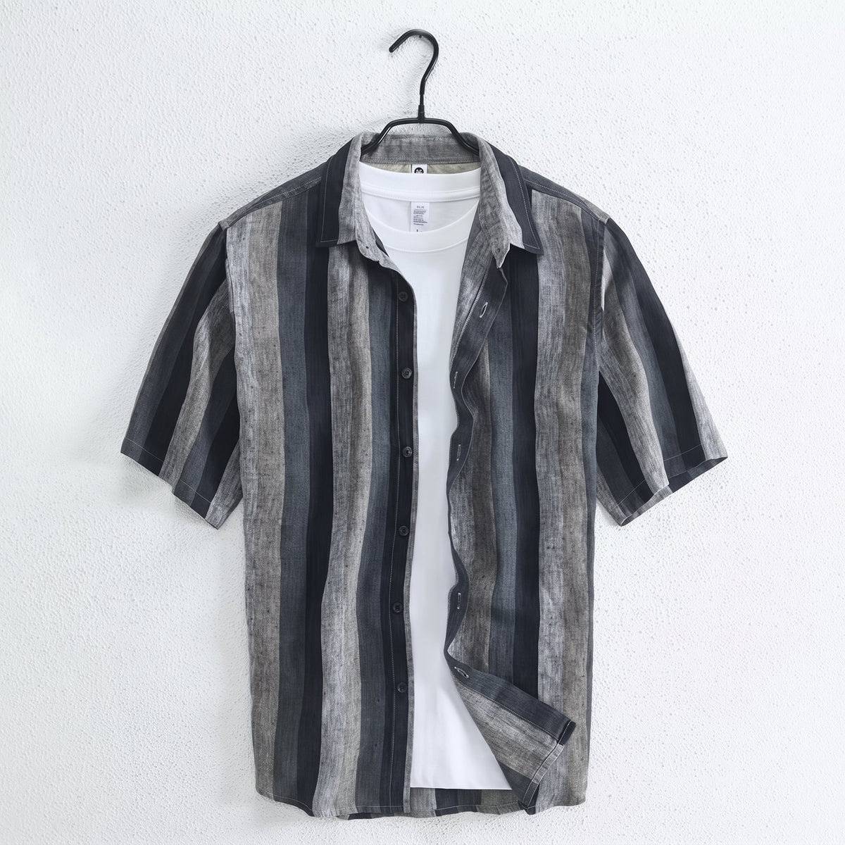 Cortez Men's Linen Button-Up Shirt hanging over a white top against a light wall