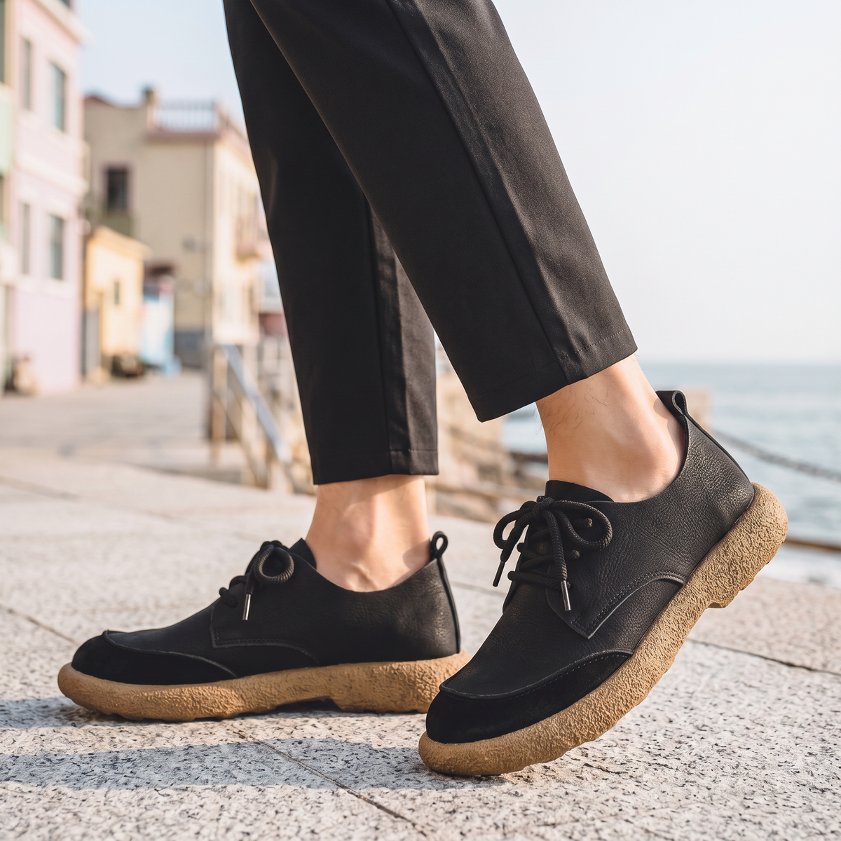 Emmett Men's Lace-Up Casual Shoes in black on a beachside town promenade