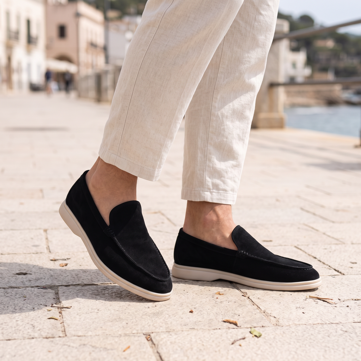 Everett Men's Slip-On Loafers in black on a beachside town promenade