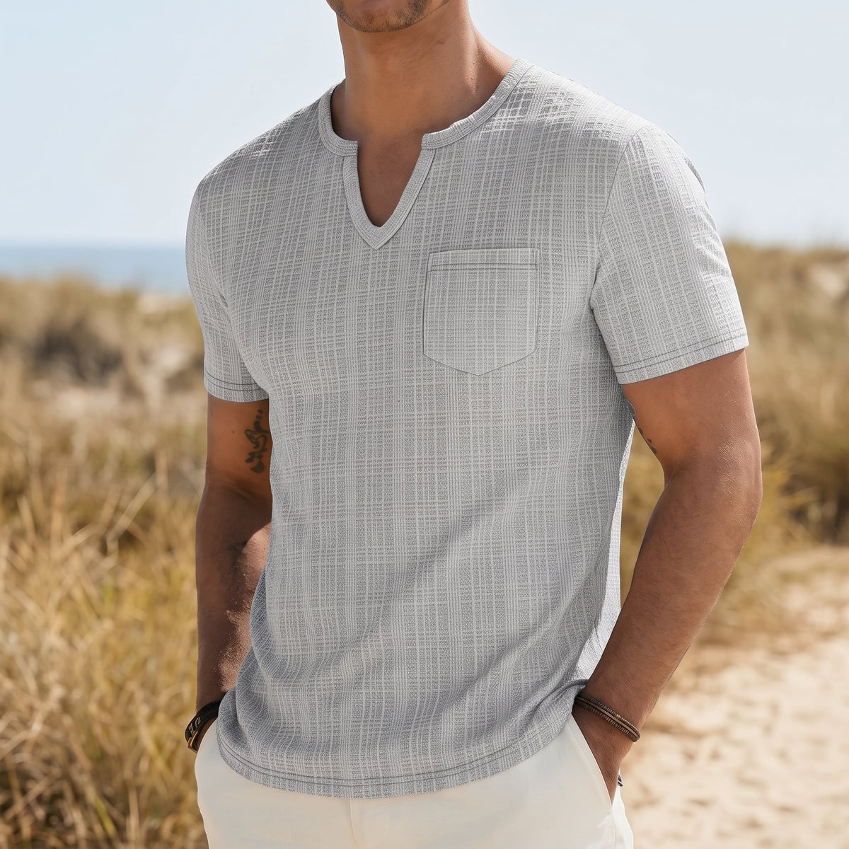 Harlan Men's V-Neck Pocket Tee Shirt in Gray in a coastal outdoor setting
