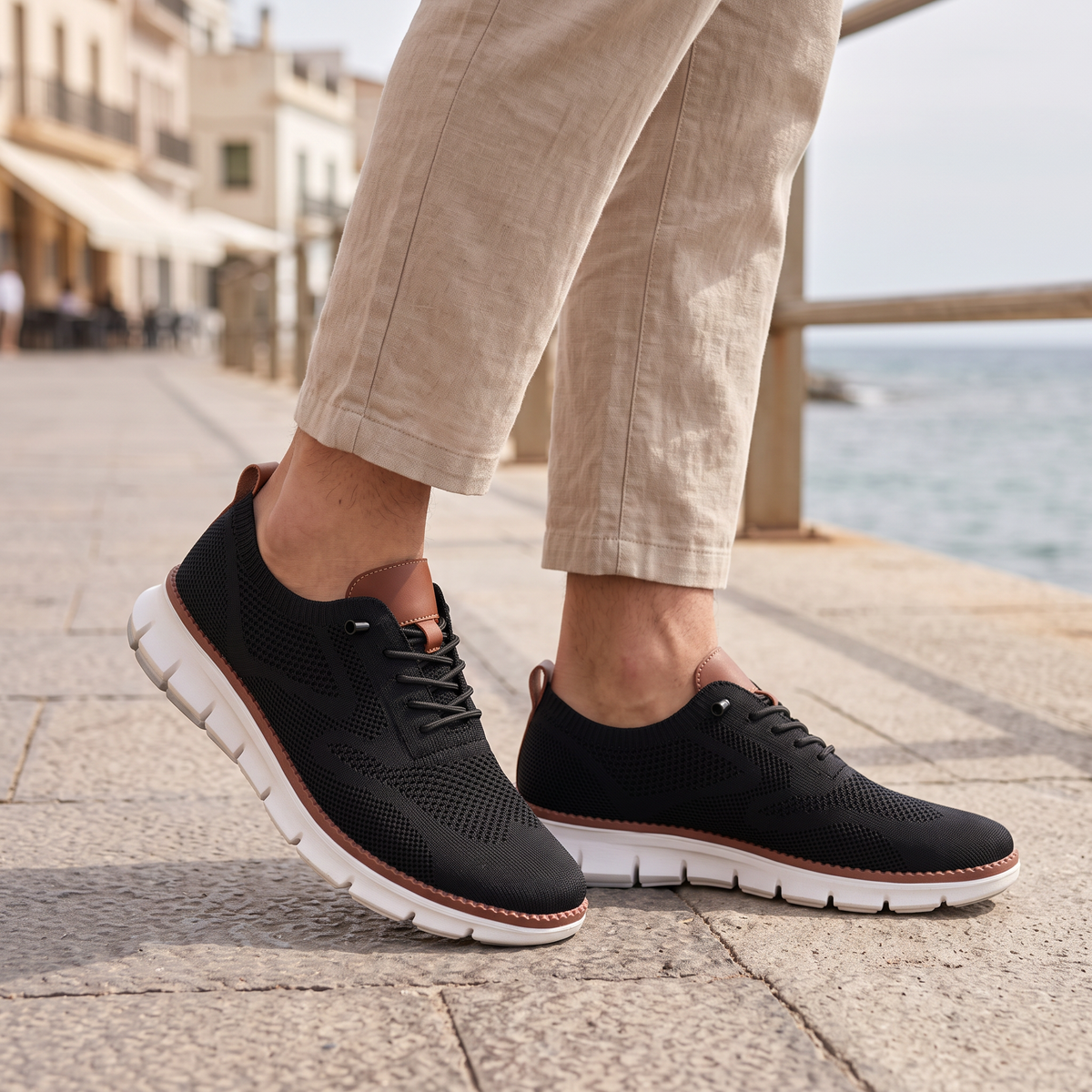 Maddox Men's Lace-Up Casual Sneakers in black on a beachside town promenade