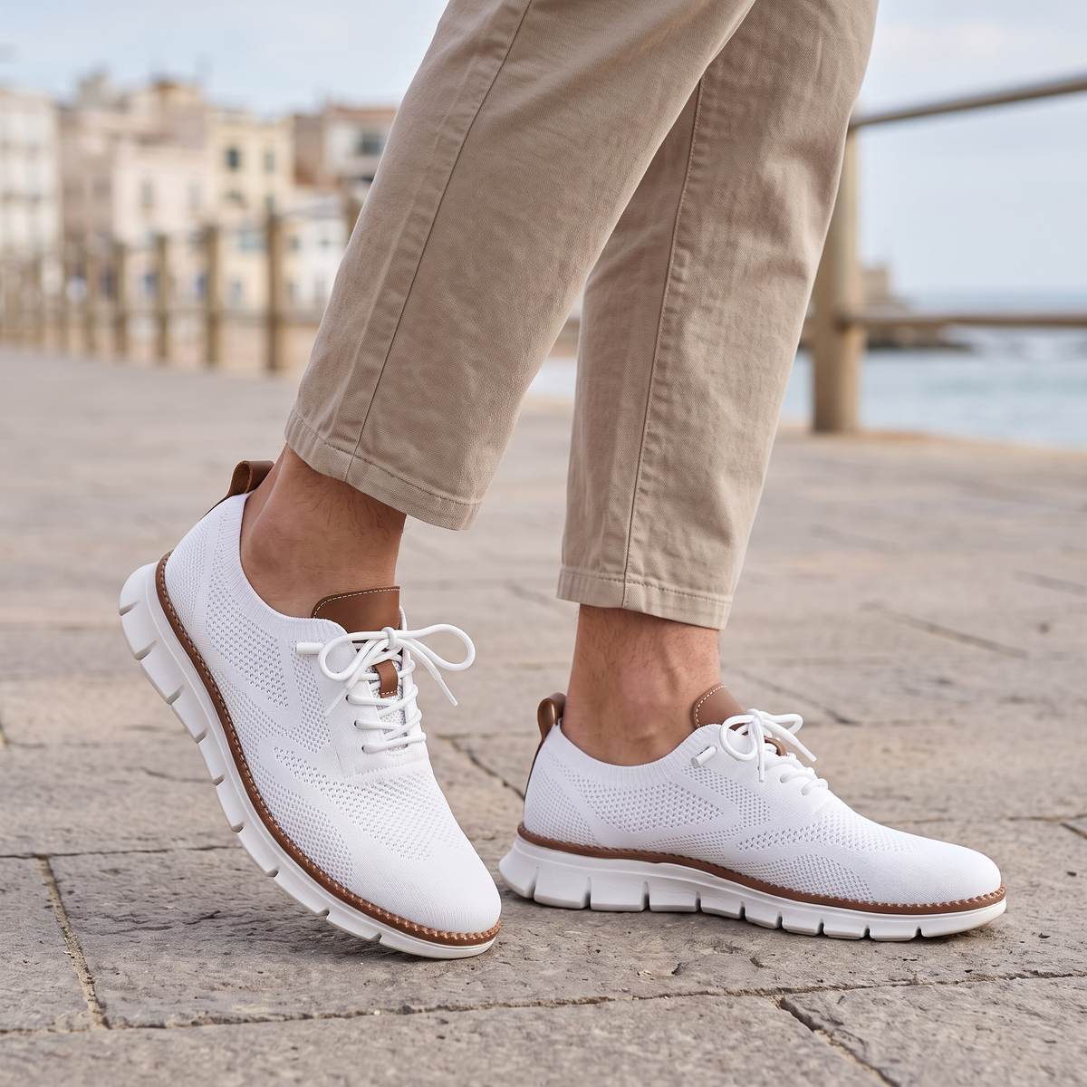 Maddox Men's Lace-Up Casual Sneakers in white on a beachside town promenade
