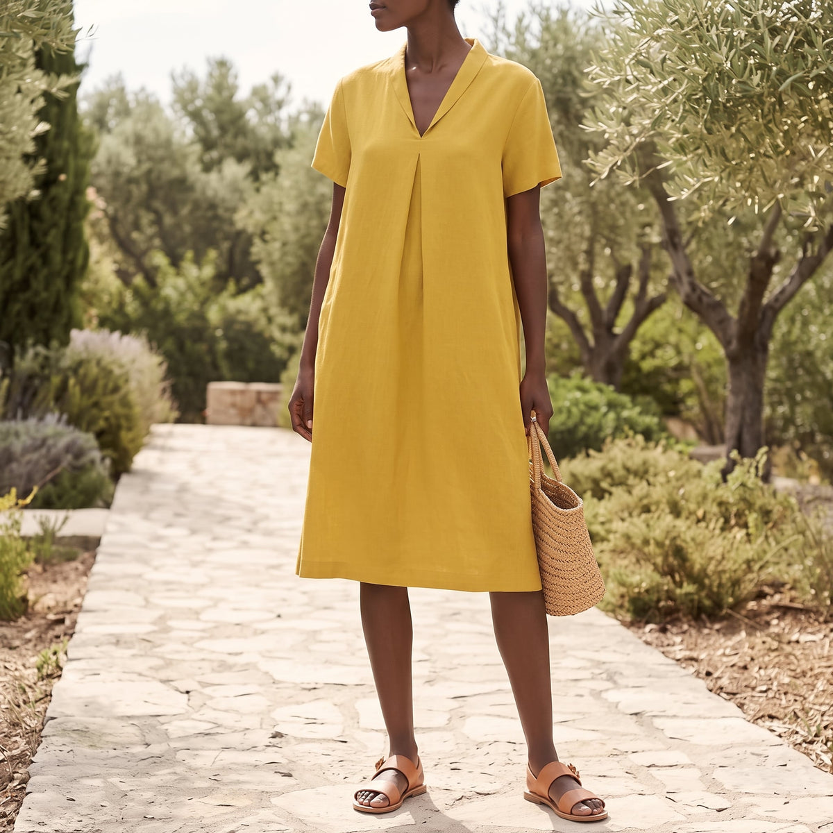 Riviera Women's Cotton V-Neck Midi Dress in Yellow in a sunlit outdoor setting